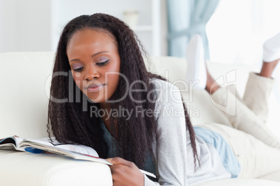 Woman with booklet on couch