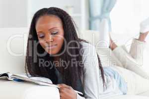 Woman with booklet on couch