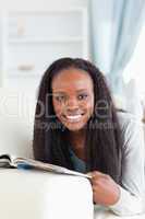 Close up of woman with booklet on sofa