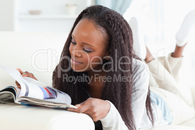 Woman looking at catalog on sofa