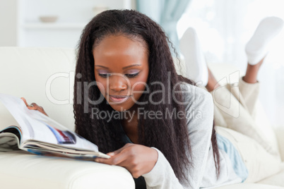 Woman looking at catalog on couch