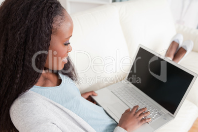 Woman on sofa with her notebook