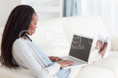 Woman on sofa surfing the internet