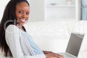 Close up of smiling woman surfing the internet