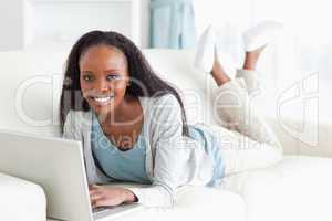 Woman on her sofa surfing the internet