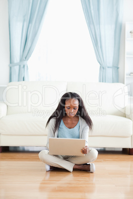 Woman sitting on floor with her laptop