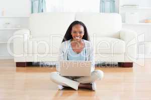Woman sitting on floor with laptop