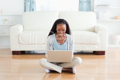 Woman sitting on floor with notebook