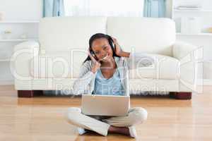 Woman sitting on the floor enjoying music