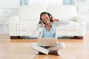 Woman sitting on floor enjoying music