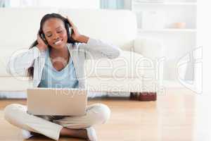 Woman on the floor listening to music
