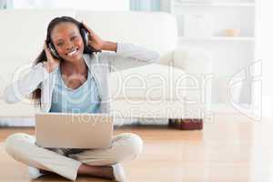 Woman on the floor enjoying music