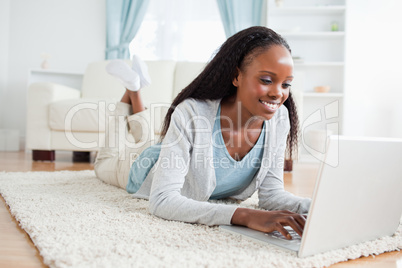 Woman lying on the floor with her notebook