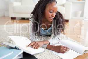 Woman lying on the floor doing a book review