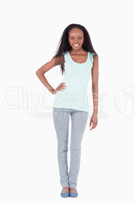 Woman with one arm akimbo on white background