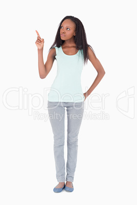 Woman pointing at something on a white background