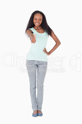 Woman giving thumb up on white background