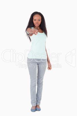 Woman pointing at you on white background
