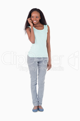 Young woman talking on the phone on white background