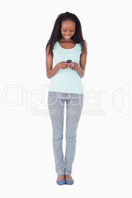 Woman writing text message on white background