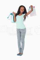 Woman stretching after shopping on white background