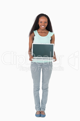 Woman showing what is on her laptop on white background
