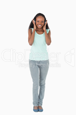 Woman listening to music on white background