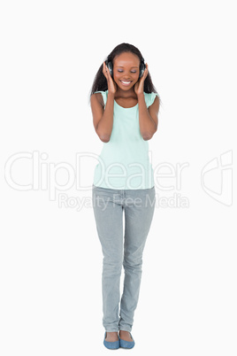 Woman enjoying music on white background