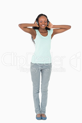 Woman listening to music with headphones on white background