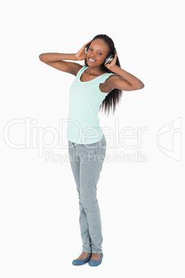 Woman enjoying music with headphones on white background