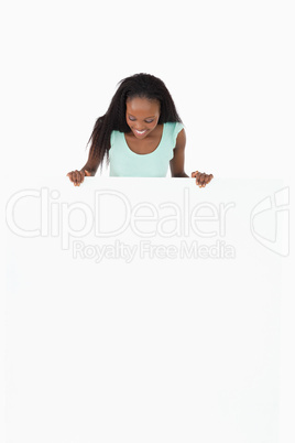 Woman looking at placeholder in her hands on white background