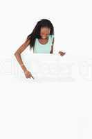 Woman pointing at placeholder on white background