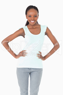 Close up of woman with arms akimbo on white background