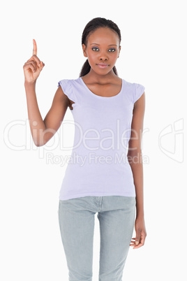 Close up of woman pointing up on white background