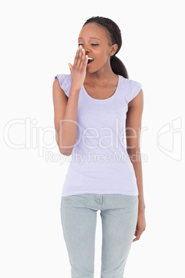 Close up of yawning woman on white background