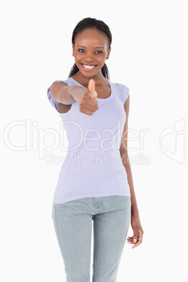 Close up of woman giving thumb up on white background