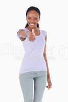 Close up of woman giving thumb up on white background