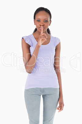 Close up of woman asking for silence on white background