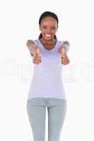 Close up of woman giving thumbs up on white background