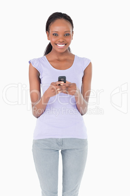 Close up of woman holding cellphone on white background