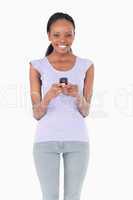 Close up of woman holding cellphone on white background