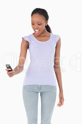 Close up of woman being surprised by text message on white backg