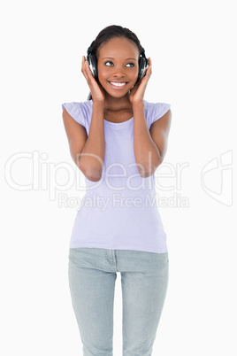 Close up of happy woman listening to music on white background