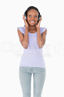 Close up of happy woman enjoying music on white background