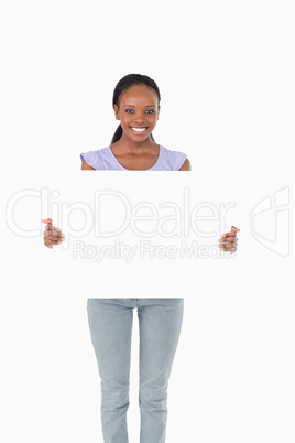 Happy woman presenting placeholder on white background