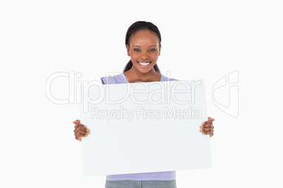 Woman holding placeholder in her hands on white background