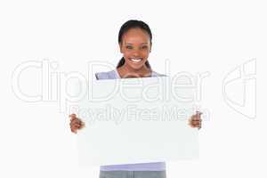Woman holding placeholder in her hands on white background