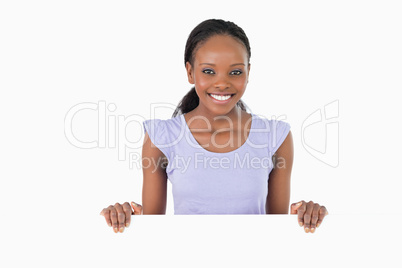 Woman with placeholder in her hands on white background