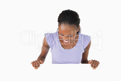 Woman looking down on placeholder on white background