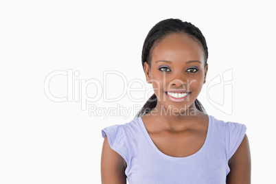 Close up of smiling young woman on white background